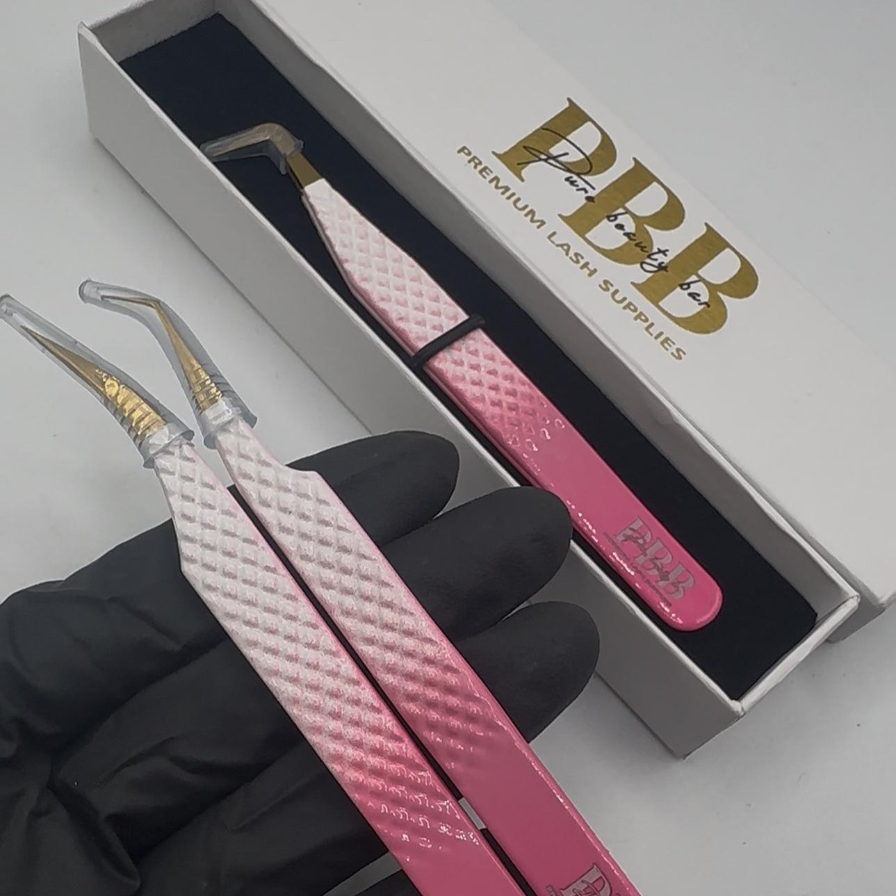 Pink Pure Beauty Bar lash tweezers with branded packaging